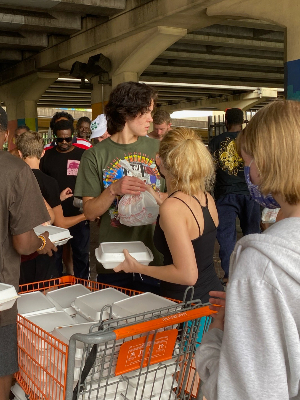 Handing out food During our Service trip.