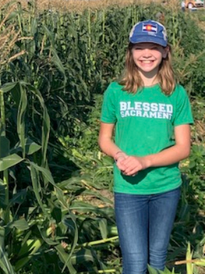 This is me picking corn for Food Bank of the Rockies. I have a frog in my hands.